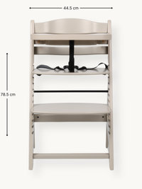 Front view of clay beige wooden highchair with dimension annotations: 44.5 cm wide, 78.5 cm tall, black safety harness on…