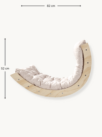 Curved pine climbing arch rocker with cream tufted cushion, dimensions annotated: 82 cm wide by 52 cm tall