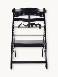 Black wooden highchair front view, no cushion, black safety harness visible at seat level, adjustable rails on sides, A-fr…