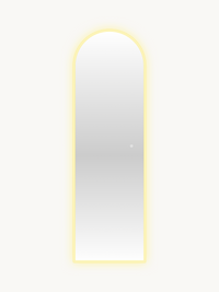 Full-length arched LED mirror with warm yellow perimeter glow illuminated, touch control button visible on glass, front vi…
