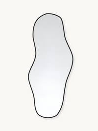 Tall asymmetric wall mirror with wavy organic outline and thin black aluminium frame against off-white background, front view