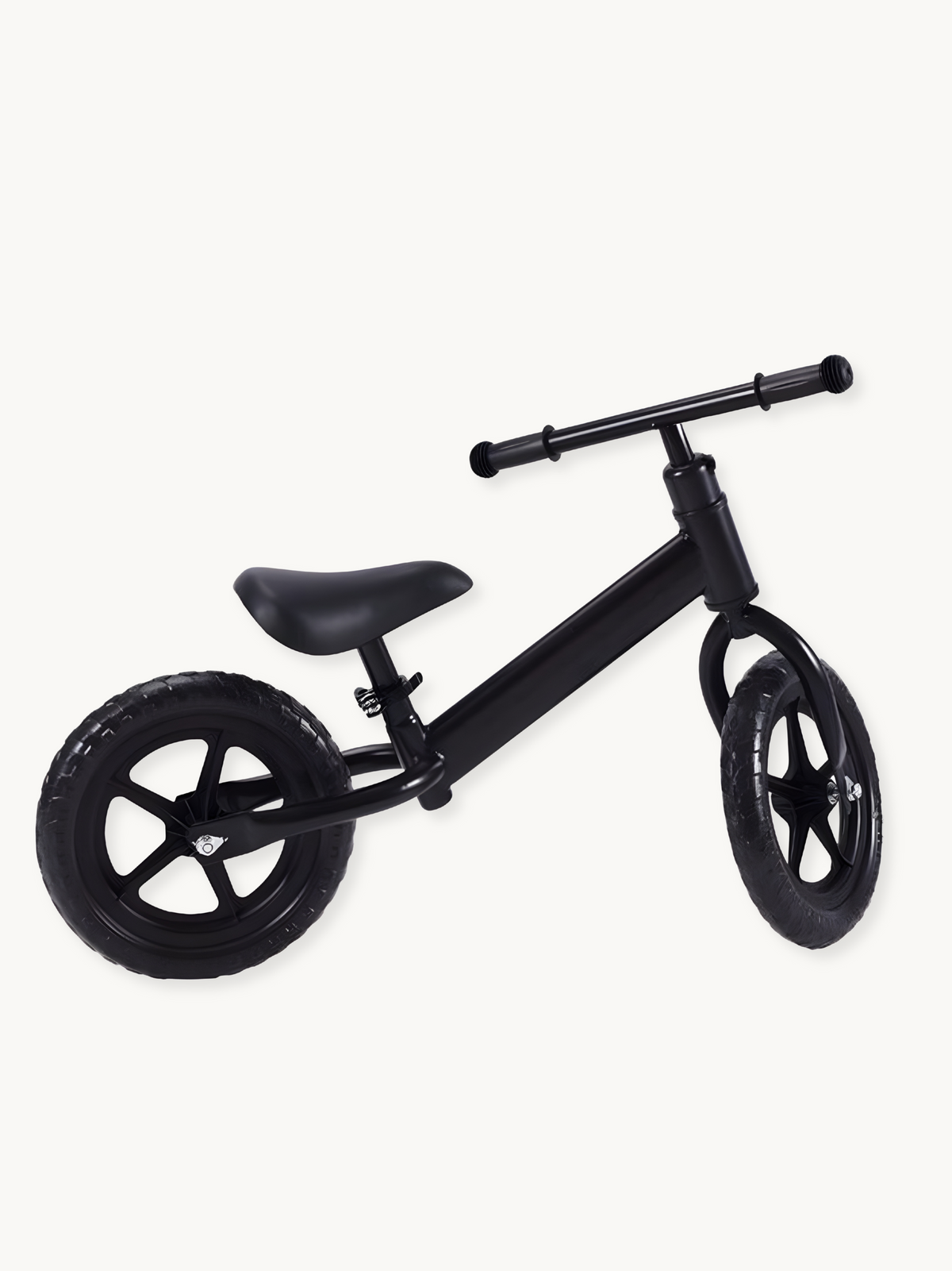 Matte black children's balance bike, angled three-quarter view, showing five-spoke wheels, padded saddle, and rubber tyres