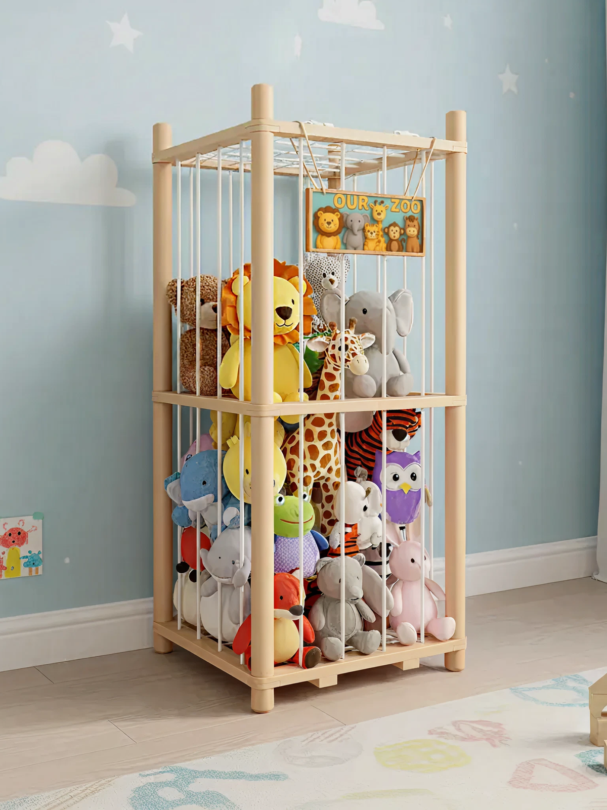 Two-tier natural pine stuffed animal cage organiser packed with colourful plush toys, shown in a blue children's bedroom