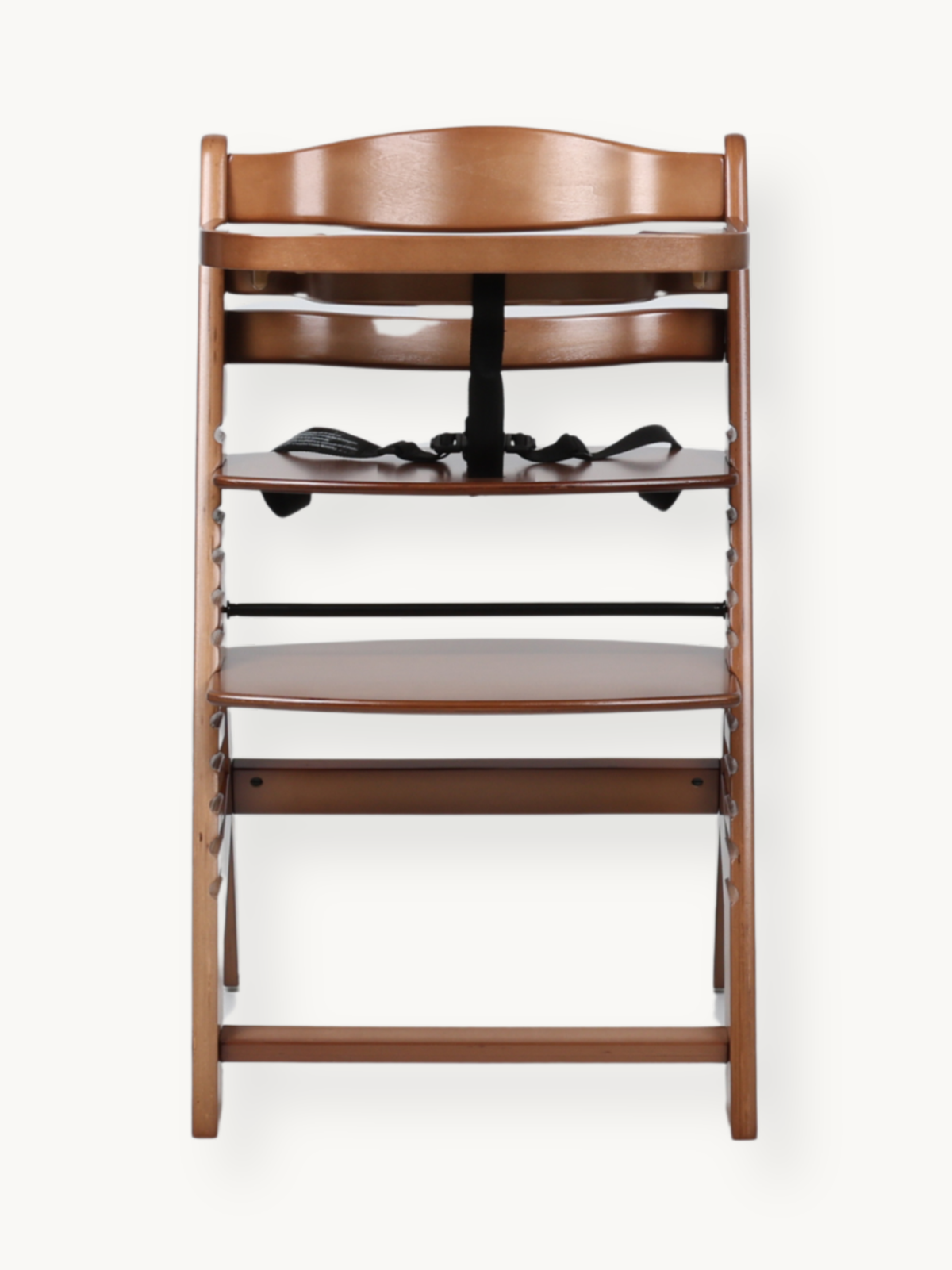 Walnut wood high chair front view showing black 5-point safety harness, adjustable seat, footrest, and open slatted frame…