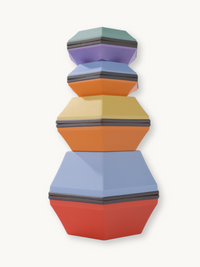 Seven multicolour hexagonal balance stones stacked in a tall tower by size, from red at base to teal at top, front view.