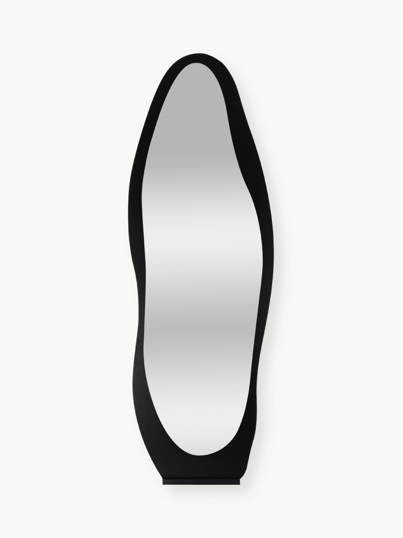 Black asymmetrical full-length standing mirror with wavy organic-shaped wooden frame, front view on white background
