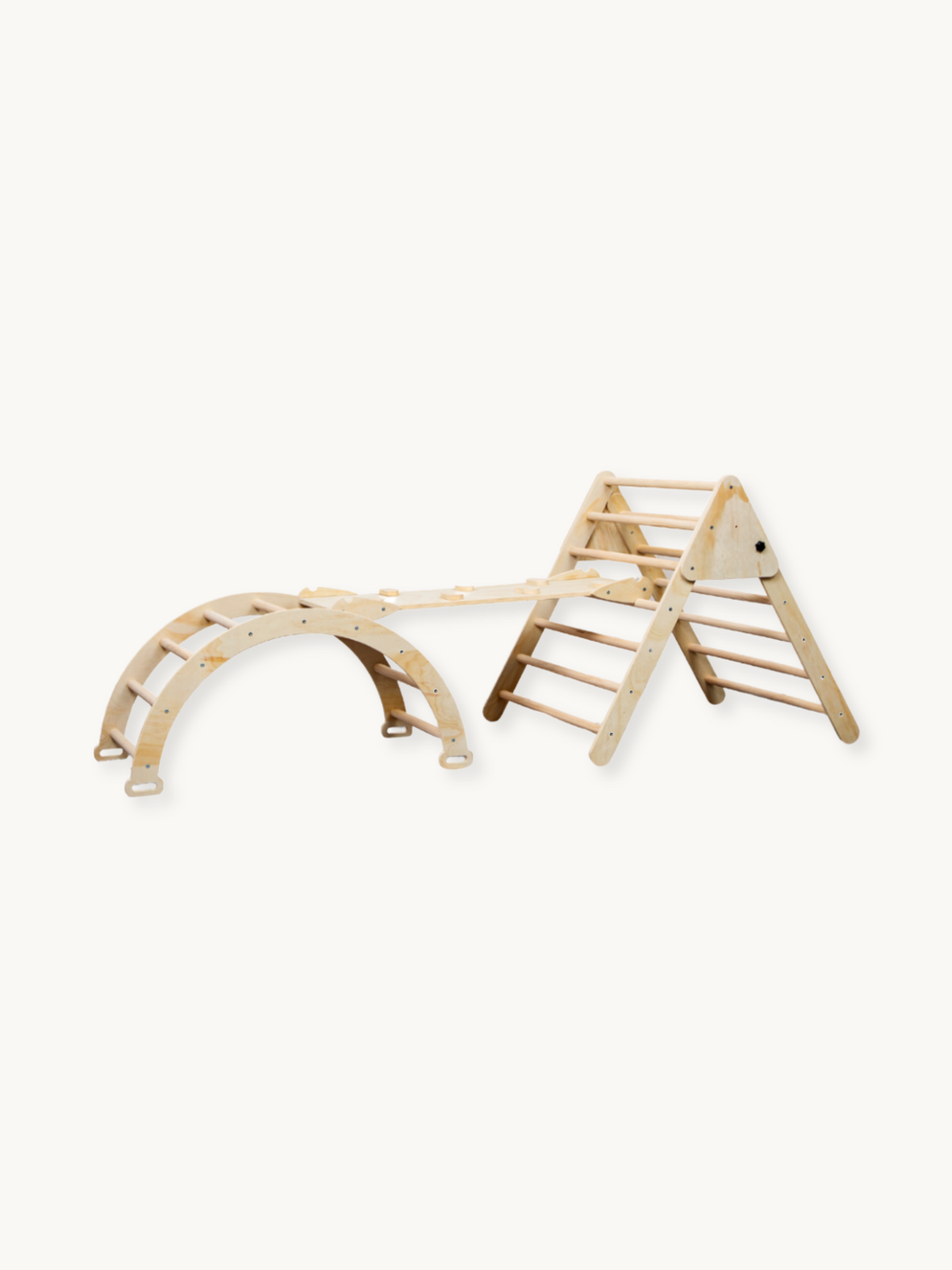 Natural wood Pikler-style 3-piece climbing set showing triangle frame, rocker arch, and ramp connected together, angled pr…