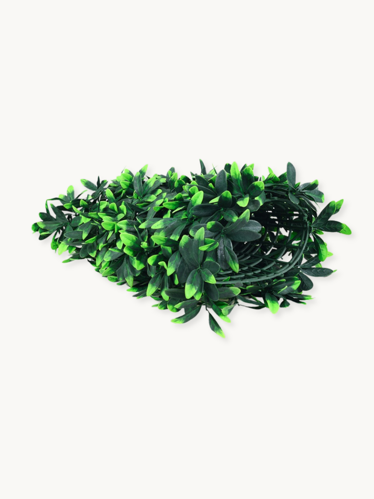 Coiled roll of artificial green leaf garland strips loosely bundled, showing dark and bright green plastic foliage, white…