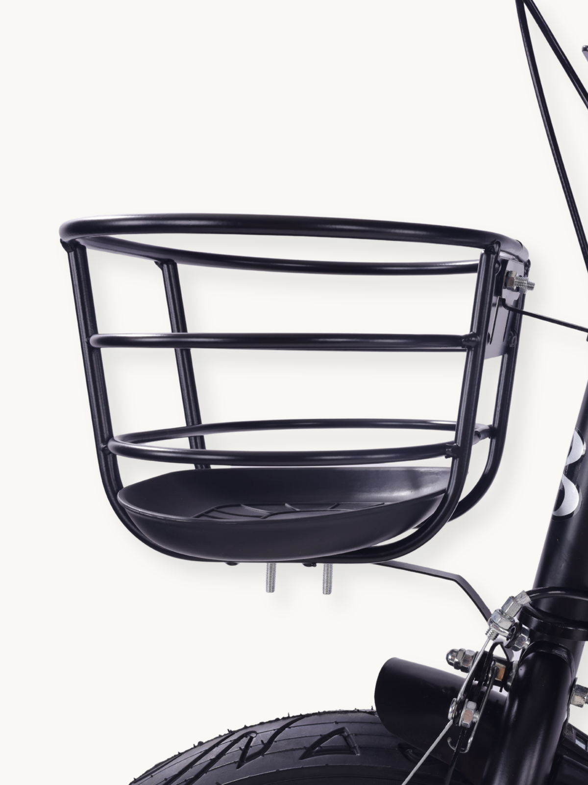 Close-up of black wire front basket with moulded plastic base, mounted above the front wheel and brake of the Borneo 12-in…