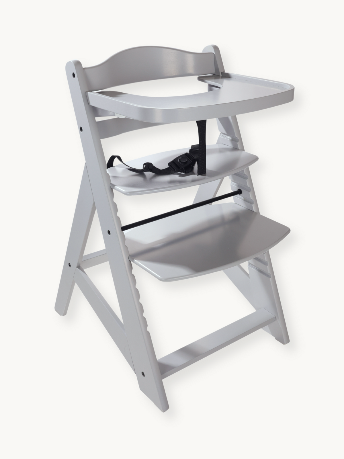 Grey wooden adjustable highchair with removable tray and black 5-point safety harness, angled three-quarter view on white…