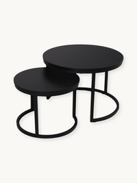 Set of 2 black round nesting coffee tables with circular steel bases, shown at staggered heights on white background