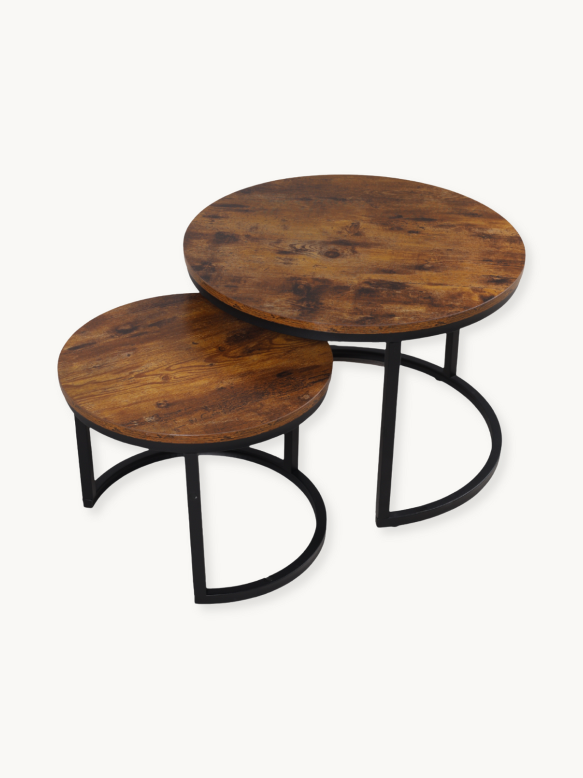 Set of two round nesting coffee tables with rustic brown wood tops and black curved steel bases, angled product view on wh…