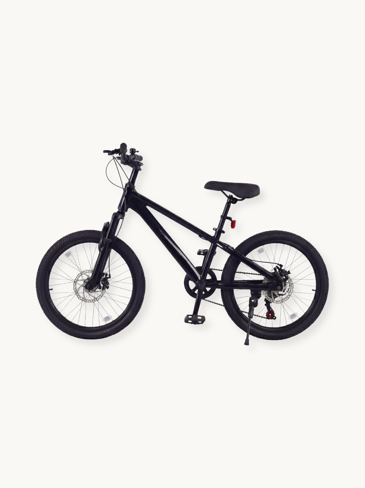 Black 20-inch kids' mountain bike, full side view, steel frame with front suspension fork and dual disc brakes on white ba…