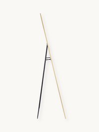 Side profile of tall arched standing mirror showing gold aluminium frame and black metal easel stand against plain background