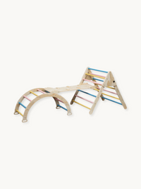Wooden Montessori climbing set with triangle, arch, and ramp connected, pastel blue, pink, and yellow rungs, white background