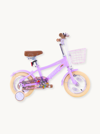 Purple 12-inch girls' Luna bike with training wheels, front wire basket, brown saddle, and rainbow sticker detail, side view