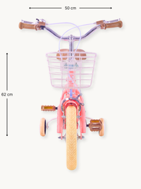 Front view of coral pink Luna 12-inch kids' bike with lilac wire basket, brown grips, cream tyres, training wheels, and 50…