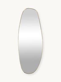 Tall asymmetric oval wall mirror with slim gold PVC frame against off-white background, front view