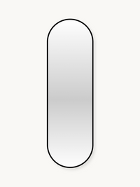 Tall capsule-shaped wall mirror with slim black aluminium frame against off-white background, front view