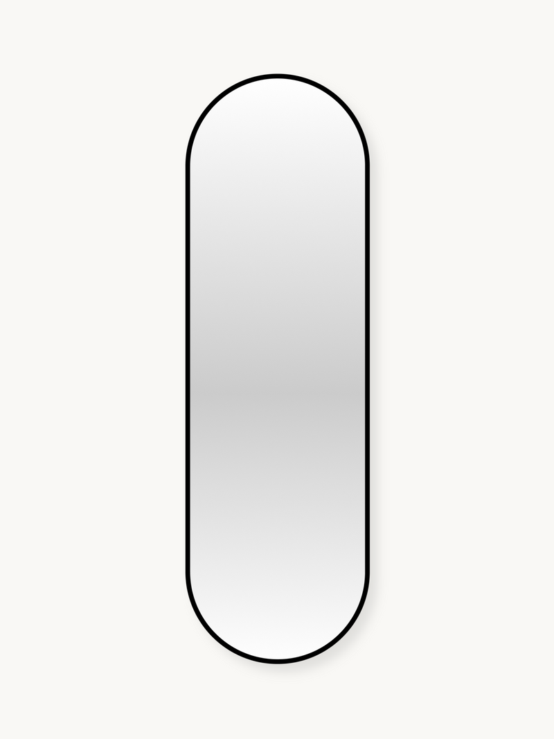 Tall capsule-shaped wall mirror with slim black aluminium frame against off-white background, front view