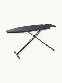 Black ironing board with cross steel frame and built-in steam unit holder, angled three-quarter view on white background