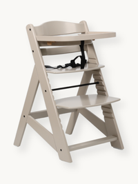 Clay beige solid wood highchair angled view, with attached tray and black 5-point safety harness, adjustable seat and foot…