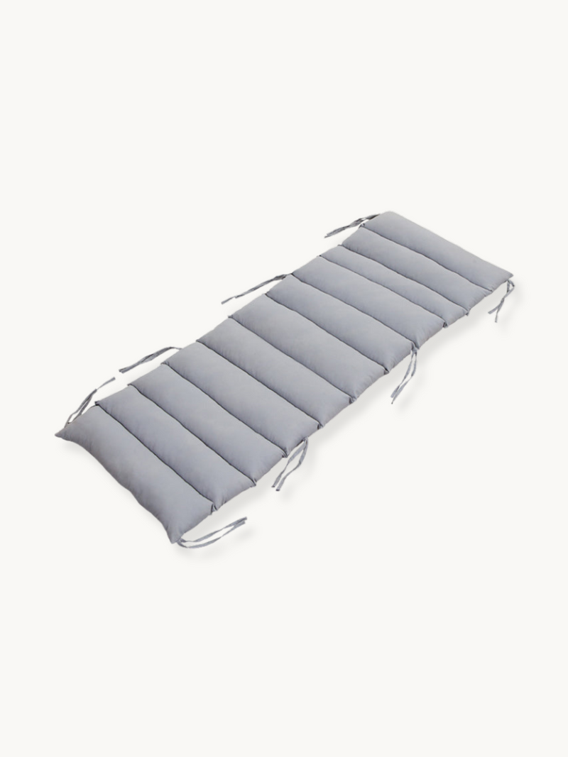 Grey padded cushion for climbing arch with tie strings at corners, angled top view on white background
