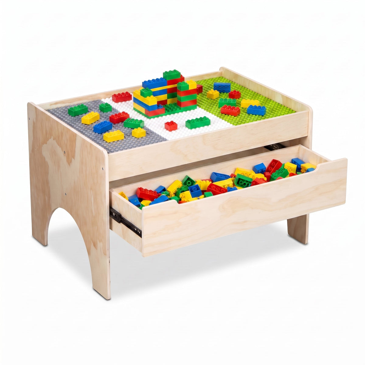 Natural wood play table angled view showing colourful bricks built on three baseplates and open front drawer filled with l…