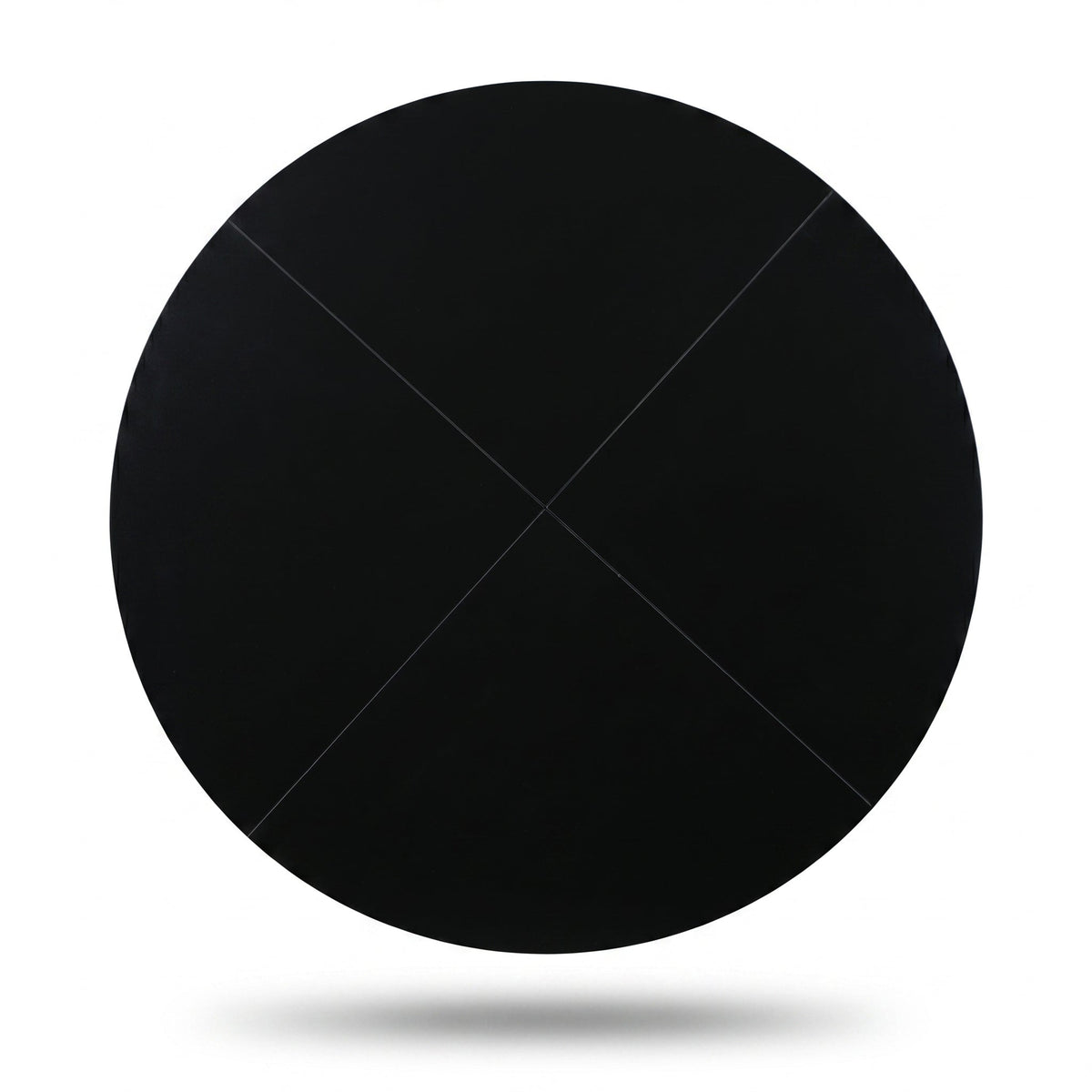 Black round tabletop viewed from above, matte black finish, four-panel construction with diagonal seam lines visible, whit…