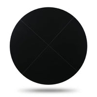 Black round tabletop viewed from above, matte black finish, four-panel construction with diagonal seam lines visible, whit…