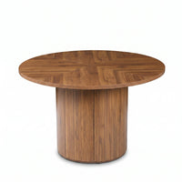Round walnut dining table with herringbone-patterned top and ribbed cylindrical pedestal base, front view on white background