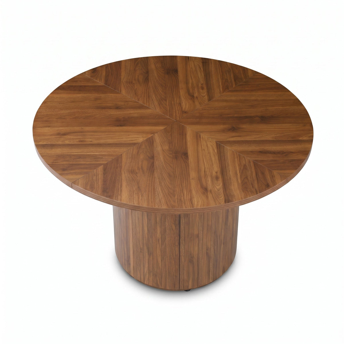 Overhead angle showing herringbone walnut veneer pattern radiating from centre of round tabletop, ribbed drum pedestal bas…