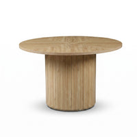 Round oak dining table with segmented circular top and vertical-slatted cylindrical pedestal base, front view on white bac…