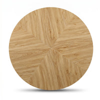 Top-down close-up of round oak tabletop with six radiating pie-segment veneer panels meeting at a central point