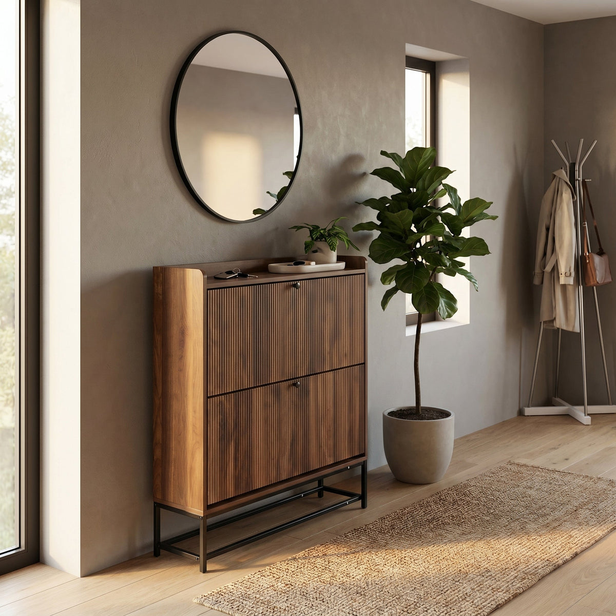Walnut shoe cabinet with ribbed flip-down doors styled in a hallway with round mirror, fiddle-leaf fig, and jute runner