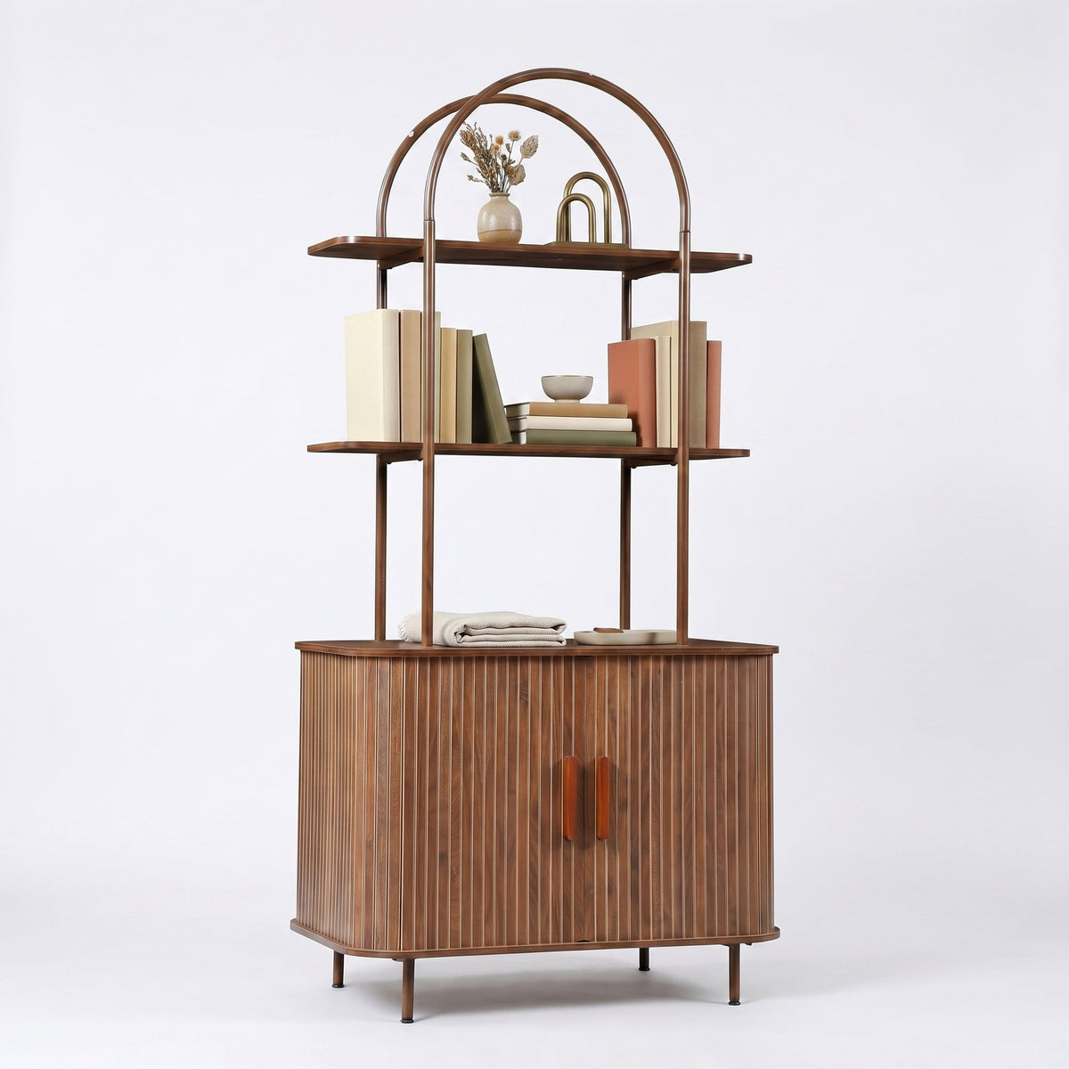 Angled front view of walnut bookcase showing arched metal frame, ribbed sliding doors with brown handles, and open shelves…