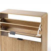Close-up of upper flip-down compartment open on oak shoe cabinet, revealing internal shelf and white metal hinge mechanism