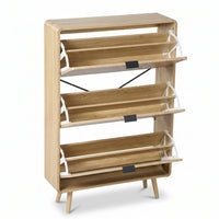 Three-tier oak-finish shoe rack with all flip-down compartments open, showing white metal hinges, slatted shelves, and spl…