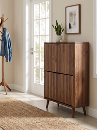 Walnut-finish shoe cabinet styled in bright entryway with coat rack, jute rug, snake plant on top, and framed art behind