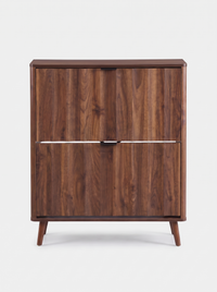 Walnut-finish Japandi shoe cabinet, front view, two closed flip-down doors with dark metal handles, splayed wooden legs, w…