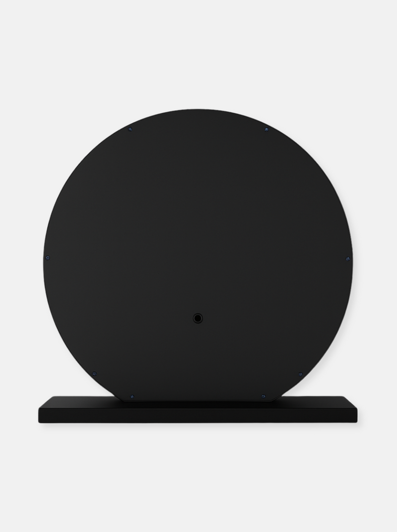 Rear view of round black Hollywood vanity mirror showing flat back panel with screws and central mount, resting on rectang…