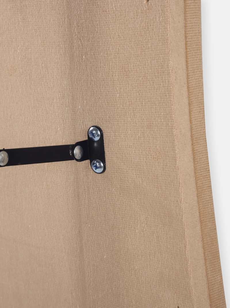 Close-up of black metal T-bracket with silver screws on the taupe suede velvet back panel of the Seraphina mirror