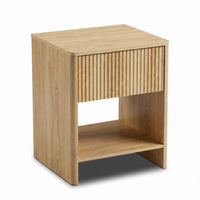 Light oak bedside table with ribbed drawer front and open lower shelf, angled three-quarter view on white background