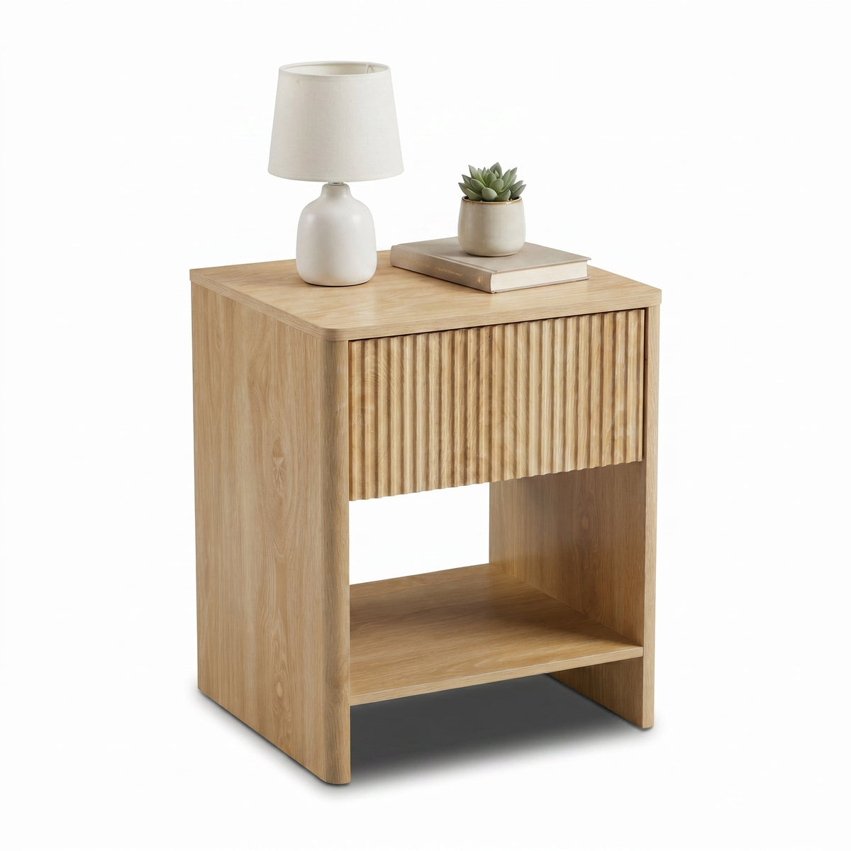 Light oak bedside table angled view, styled with white table lamp, stacked books and small succulent on top