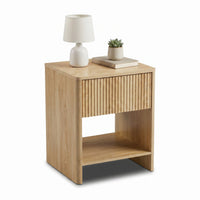 Light oak bedside table angled view, styled with white table lamp, stacked books and small succulent on top
