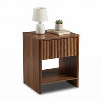 Walnut nightstand styled with white table lamp, succulent and stacked books on top, ribbed drawer and open shelf shown at…