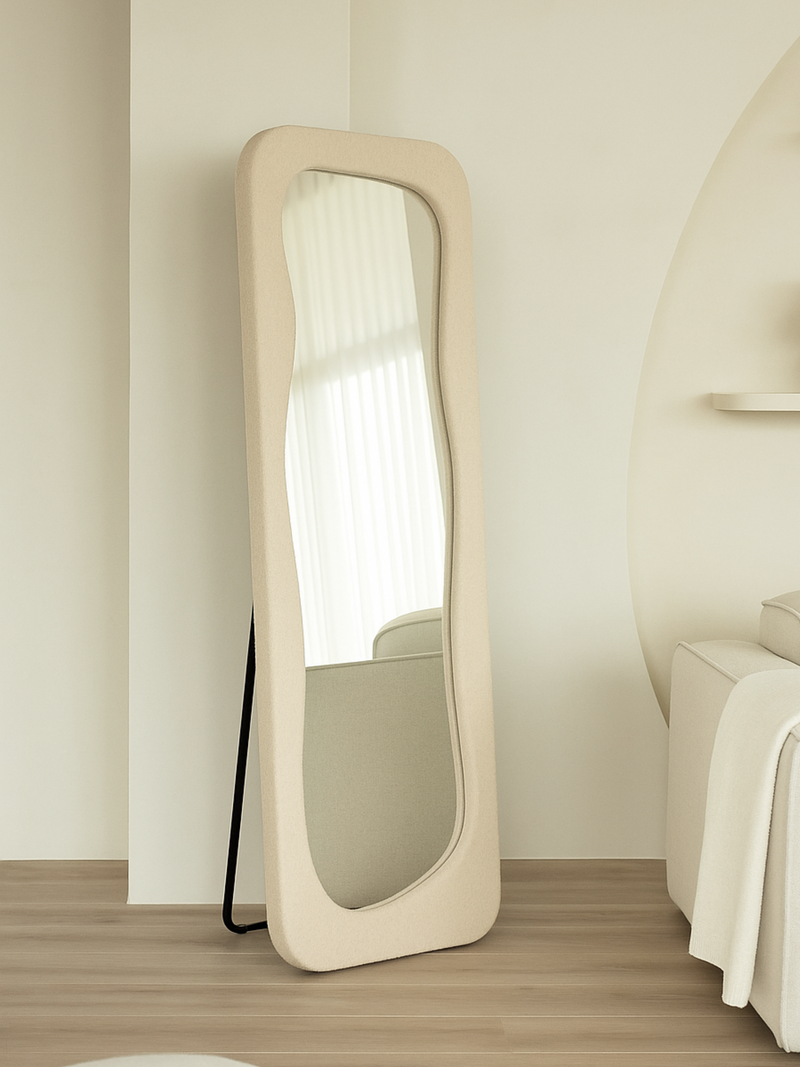 Felis standing mirror in teddy white, leaning against wall on metal support stand, wavy glass visible, bedroom lifestyle s…