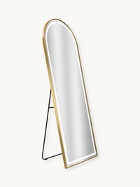 Gold arched full-length LED mirror on black easel stand, angled three-quarter view, white backlight visible, plain background
