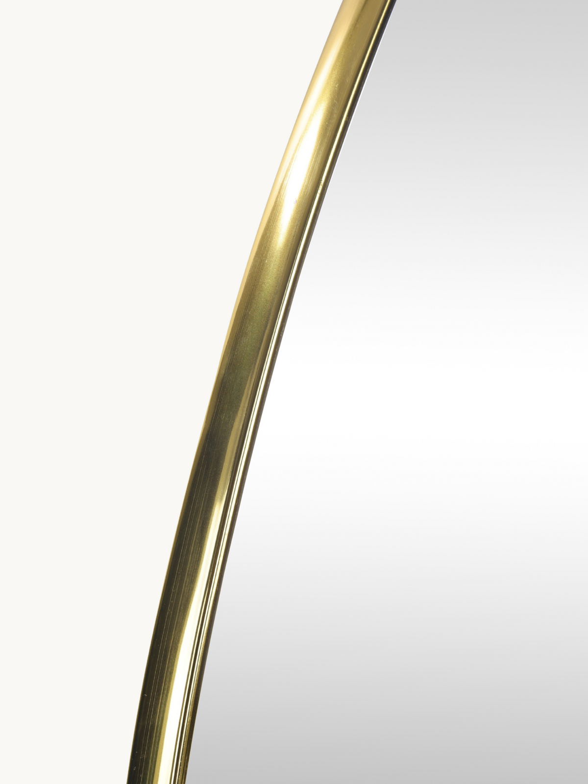 Close-up of the brushed gold PVC frame curve on the Matteo organic wall mirror, showing metallic sheen and slim profile de…