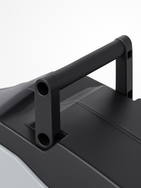 Close-up of black matte carry handle on top of hose reel casing, showing tubular grip and bracket mounting detail